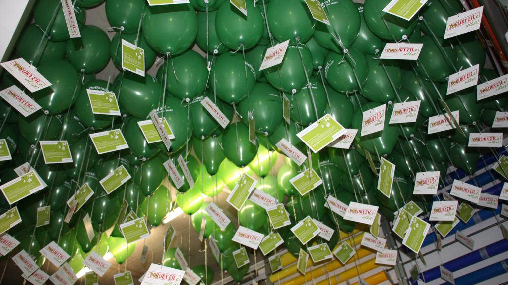 The green balloons from the "Judge for Yourself" event, which are floating under the ceiling at our company.