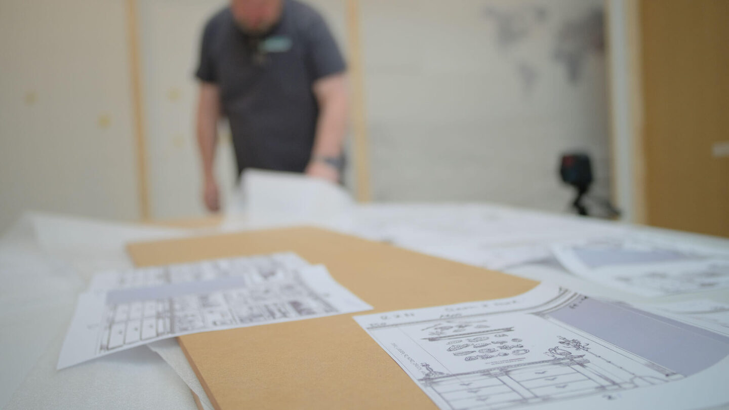 Exhibition technology and consulting. Photo-advertising staff member analyzes setup plans.
