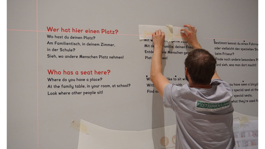 Humboldtforum foil plots are put on the wall by photo advertising employees