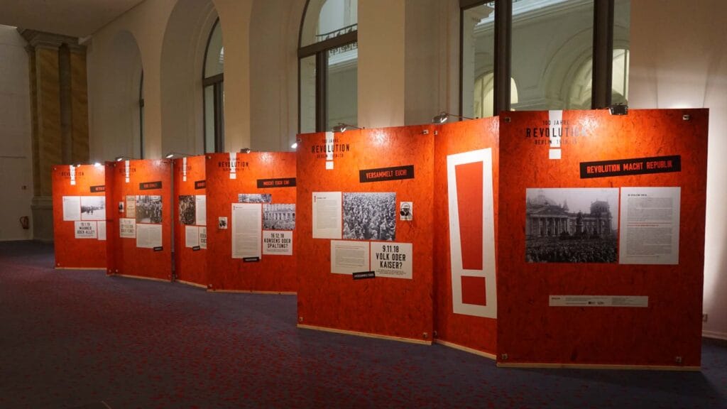 100 Years of Revolution orange exhibition walls in Leporello arrangement